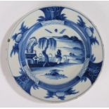18th Century Delft plate, with a figure looking up at a tree and building, 23cm wide