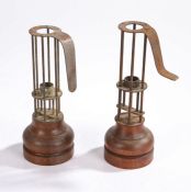 Two bird cage candlesticks, the metal frames above the turned wooden bases, 25cm and 24cm high, (2)