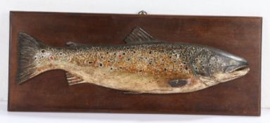 A 20th Century primitive carved fish trophy, of a trout on a rectangular board, 56cm x 22cm