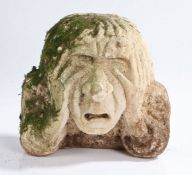 A carved stone head, depicting a gentleman holding his face with both hands, XIV carved to the back,