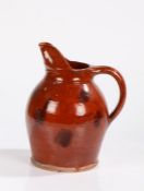 19th Century French pottery jug, of burnt red glaze and spotted design, 27cm high