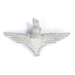 World War Two plastic economy cap badge to the Parachute Regiment, in silver grey, two blades to the