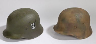 Two Movie prop/reenactor Second World War German combat helmets, one in 'Normandy' camouflage, the