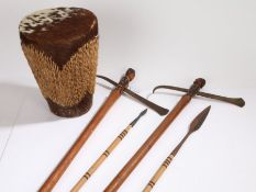 Ornamental African weaponry, two ceremonial spears, two axes, together with a cowhide drum, (5)