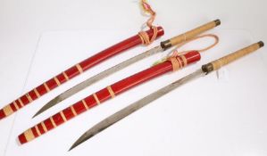 Pair of ornamental Burmese Dha, held in wooden scabbards with rope suspension straps, (2)