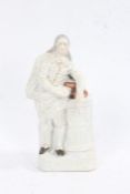 19th century Staffordshire figure, in the form of John Milton, modelled standing by a plinth of