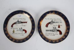 Pair of Westminster Gun Co plates depicting 18th century pistols with a blue and gilded rim (2)