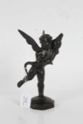 Bronze figure depicting a cherub holding a dolphin, on an octagonal domed base, 21.5cm high