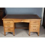 20th century desk, with a leather inset top above seven draws, 76cm high 150cm wide