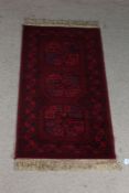 Super Keshan carpet, the red ground with triple elephant foot lozenge pattern centre and tasselled
