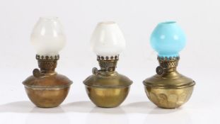 "Pixie" small oil lamp with white glass shade above a brass reservoir, 12.5cm high, "The Original