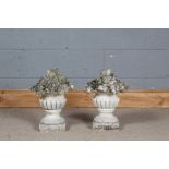 Pair of stone composite decorative gate post finials in the form of gadrooned urns full of