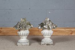 Pair of stone composite decorative gate post finials in the form of gadrooned urns full of