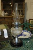 Best British Make oil lamp, with clear glass chimney above a faceted clear glass reservoir, chrome