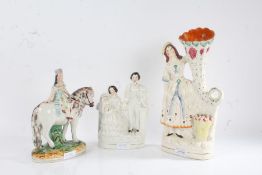 Three Victorian Staffordshire figures, to include a young girl on horseback, a cornucopia vase