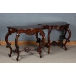 Pair of mahogany serpentine fronted console tables with foliate decoration, with saber legs united