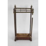 Late Victorian brass walking stick stand, the sloping top with six divisions above a drip pan to the