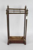 Late Victorian brass walking stick stand, the sloping top with six divisions above a drip pan to the