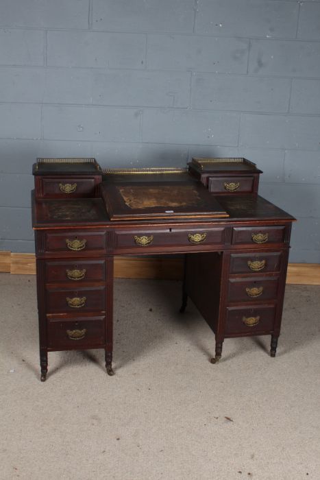 Victorian mahogany twin pedestal desk, the three quarter brass galleries above small drawers and