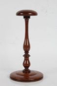 19th Century turned mahogany wig stand, the domed top above a turned stem and reeded foot, 25cm
