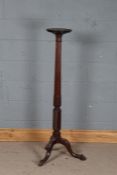George III style mahogany torchere stand, with a circular pie crusted top on a foliate carved column