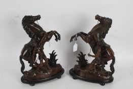 Pair of cast metal Marley horses, marked to base "ASCO MADE IN ENGLAND", presented on oval wooden