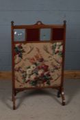 Early 20th century oak framed fire screen, inset four glass panels and floral fabric below, 112cm