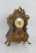 20th Century French style gilt mantle clock, with a floral pediment and floral design to the front