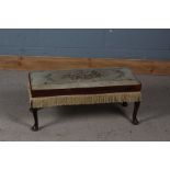 Rectangular footstool with a needlework top depicting floral arrangement raised on cabriole legs,