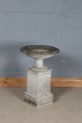 Reconstituted stone bird bath, the scalloped bowl above a waisted stem and stepped square plinth