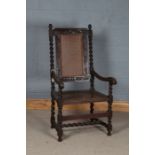 18th Century style elbow chair, the turned finials above a scroll carved cresting rail, cane back