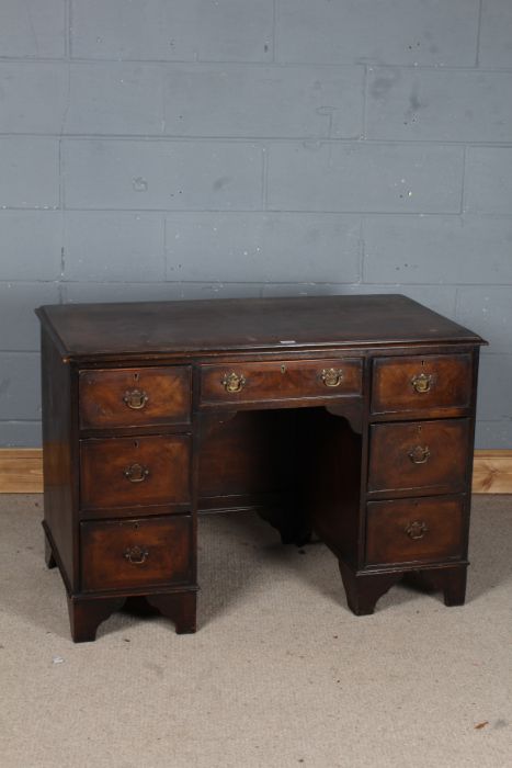 Victorian walnut desk, with seven draws with swan neck handles, raised on bracket feet, 108cm wide