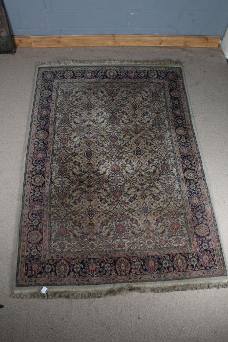 Large middle eastern rug, the blue and cream ground, with a floral repeating pattern to the center
