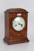 20th Century mantle clock the arched pediment with brass inlay, the front with inlaid floral design,