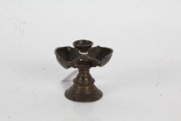 19th Century Indian bronze butter lamp, the dished circular top flanked by two oval wells, raised on
