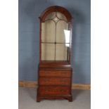 Walnut veneered display cabinet, the arched glazed top with three glass shelves above a base