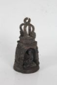 Tibetan bronze deity bell, the quatrefoil pierced top above an arched bell with depiction of a
