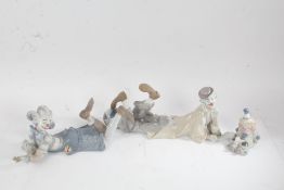 Three Lladro clown figures, two displayed in a laid down position, the largest 37cm long (3)