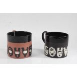 Two Wedgwood souvenir mugs, the first in terracotta with black glaze, white cameos and black