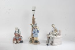 Three Lladro figures, a man with a teddy bear on his lap, father and child reading, one purposed