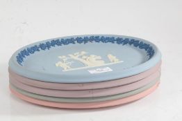 Five Wedgwood jasperware oval plates, four with cameos depicting cupid and Psyche tied to a tree, to