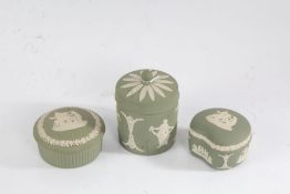 Three Wedgwood green jasperware pots and covers, all with classical figural decoration, the