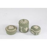 Three Wedgwood green jasperware pots and covers, all with classical figural decoration, the