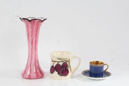 Moorcroft mug decorated in the plum pattern, Carlton china cabinet cup and saucer, the blue ground