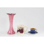 Moorcroft mug decorated in the plum pattern, Carlton china cabinet cup and saucer, the blue ground