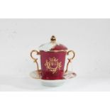 Limoges porcelain chocolate cup, cover and stand, the red ground with gilt foliate decoration,