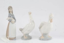 Lladro figure modelled as a young lady holding a piglet, 17cm high, two Nao ducks, 15cm and 14.5cm