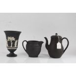 Wedgwood black basalt vase, the flared tapering central section with white cameos depicting