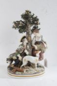 Capodimonte porcelain figural group depicting a huntsman seated beneath a tree in discussion with