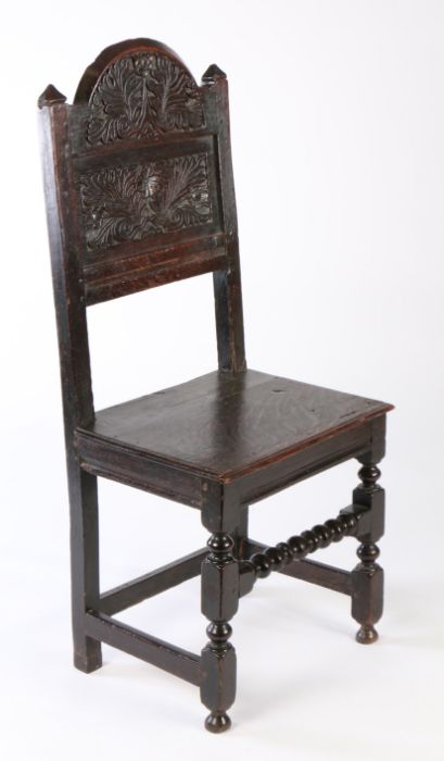 A Charles II oak backstool, Lancashire/Cheshire, circa 1680, the arched cresting foliate carved, - Image 2 of 2